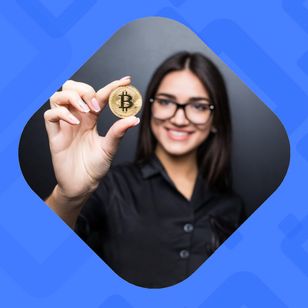 person holds a gold coin with bitcoin symbol