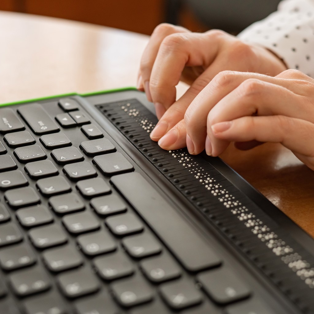 person using braille keyboard